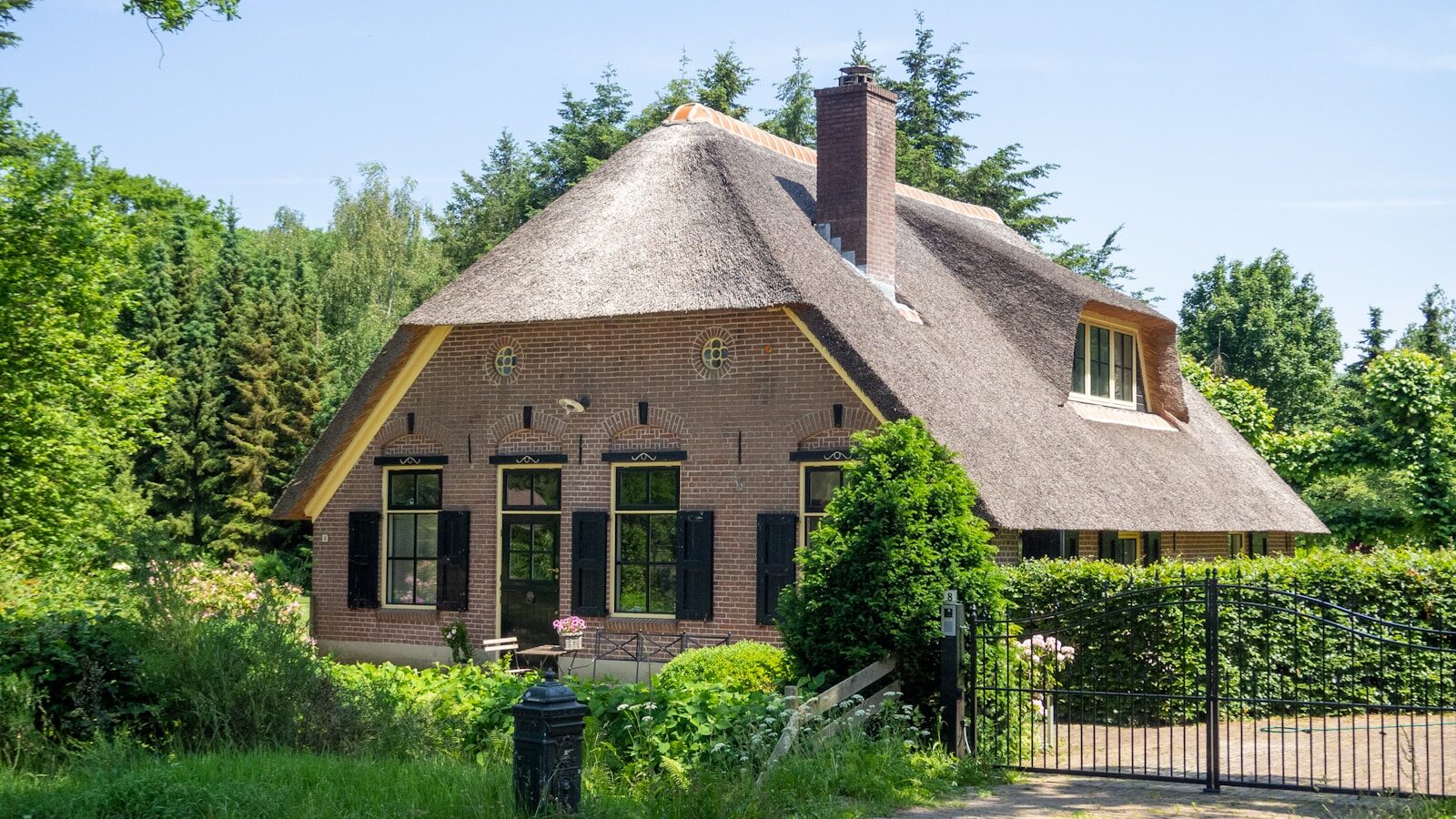 brown concrete house near green trees during daytime